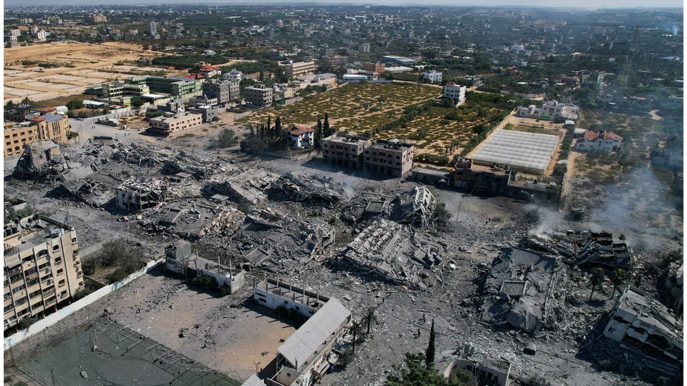 An aerial view shows destroyed buildings in al-Zahra city south of Gaza City on 20 October 2023 following Israeli bombardment overnight amid ongoing battles between Israel and the Palestinian group Hamas.