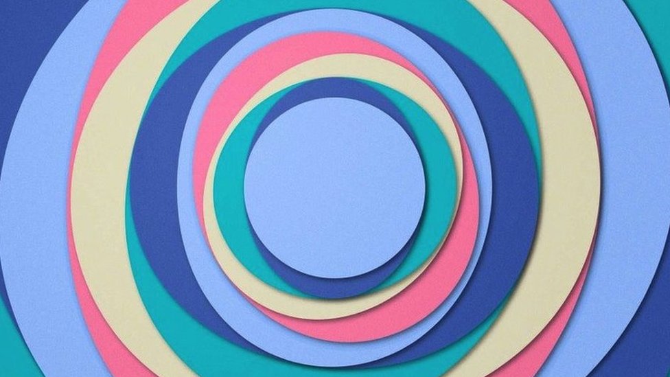 A series of circles in different colours such as purple, indigo, green, cream and pink