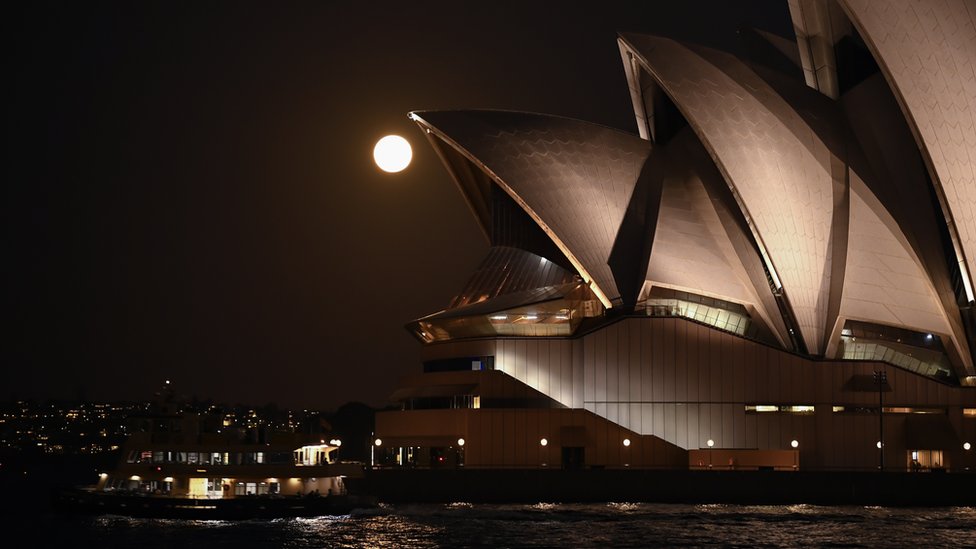 The Moon is seen over Sydney's Opera House, Australia. Photo: 27 May 2021