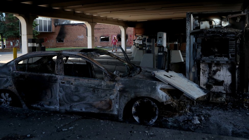 A burnt vehicle in the aftermath of protests in Minneapolis, Minnesota, 30 May 2020