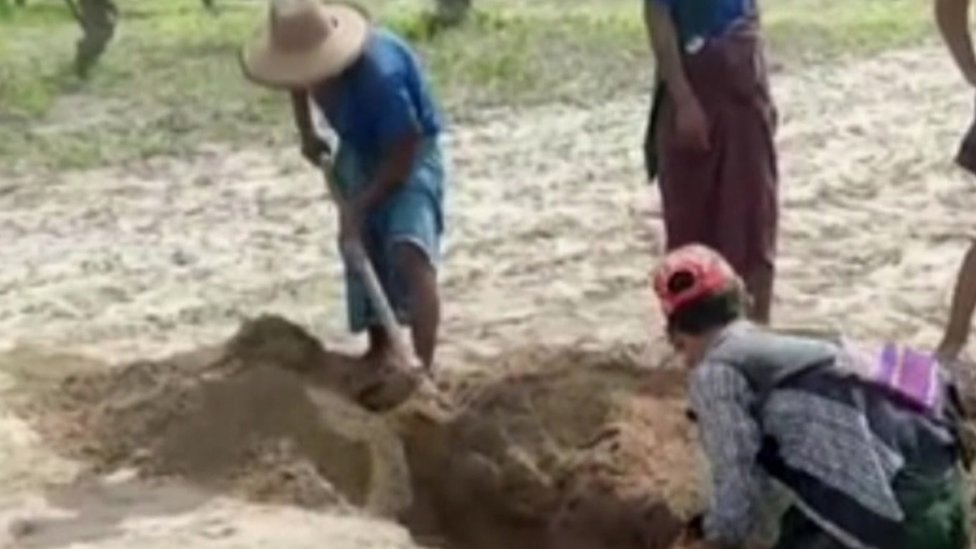 Two people digging