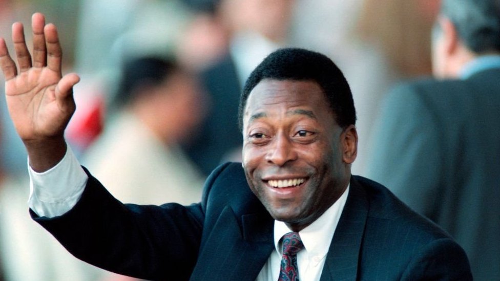 Pele salutes a crowd during a public engagement in 1995 as Brazil's Sport minister