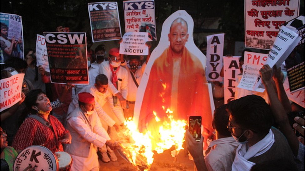protesters burn an effigy of UP chief minister Yogi Adityanath over the Hathras rape case