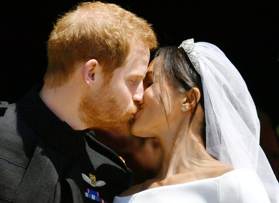 Prince Harry and Meghan Markle kiss on the steps of St George's Chapel in Windsor Castle