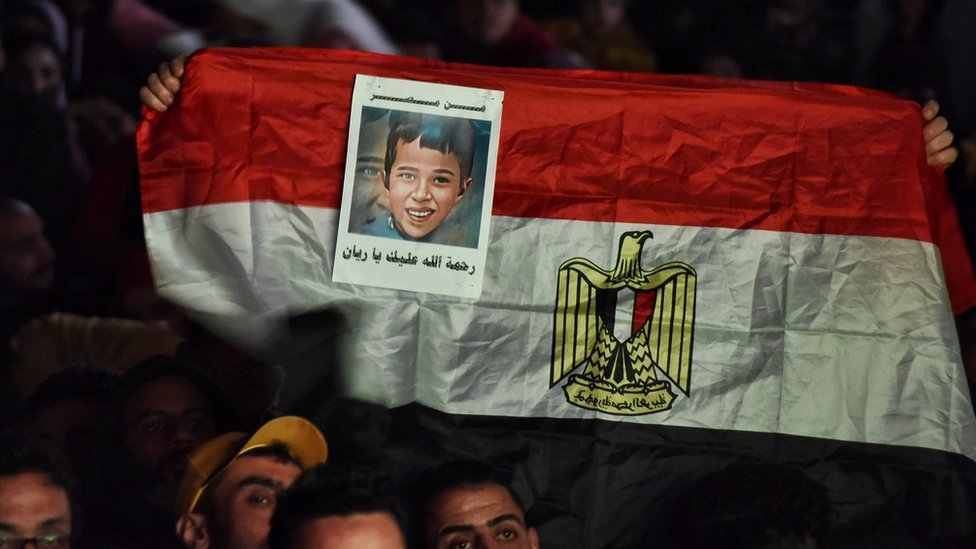 An Egyptian flag with the photo of Rayan whose dead body was found five days after he fell from a well in Morocco, is seen in the capital Cairo, in Egypt on 6 February 2022