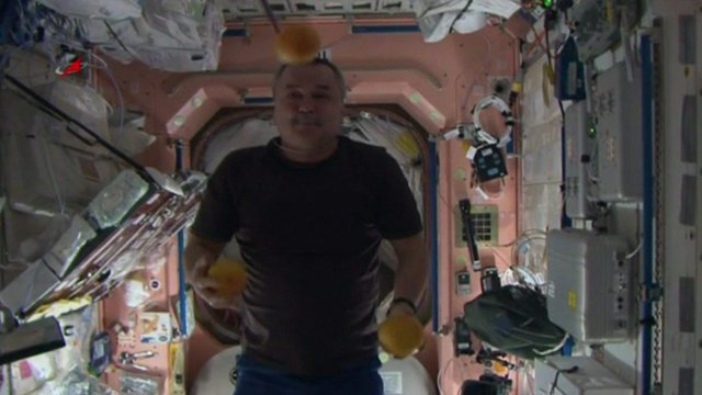 Cosmonaut juggling oranges