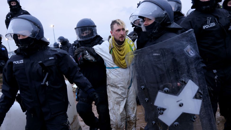 Activists clash with riot police at the settlement of Luetzerath next to the Garzweiler II open cast coal mine on January 11, 2023 near Erkelenz, Germany