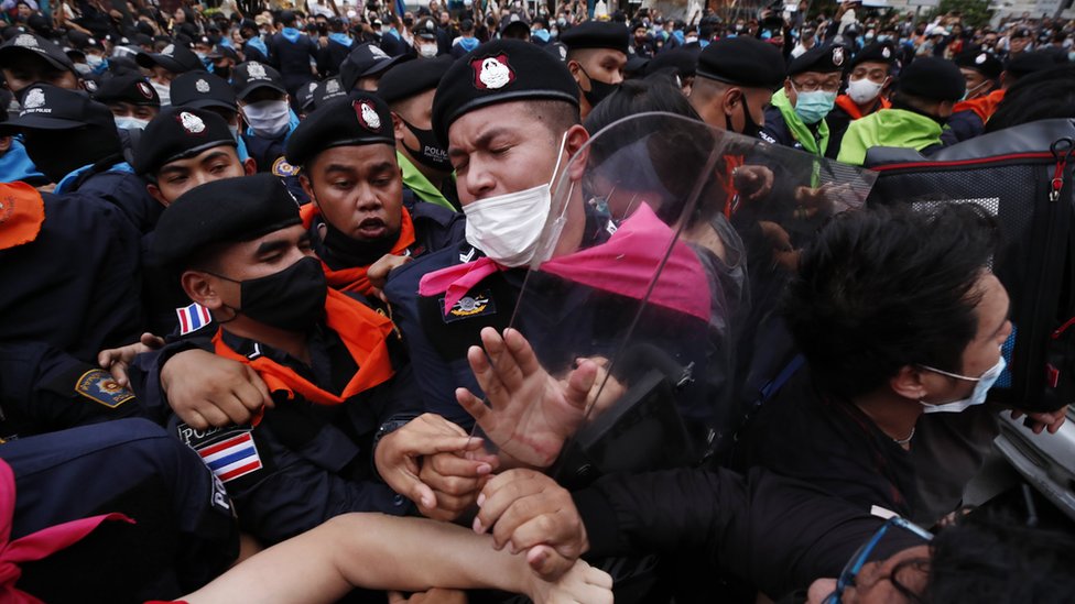 Pro-democracy protester and police officers clash during rally against the state of emergency at Ratchaprasong district in Bangkok, Thailand, 15 October 2020.