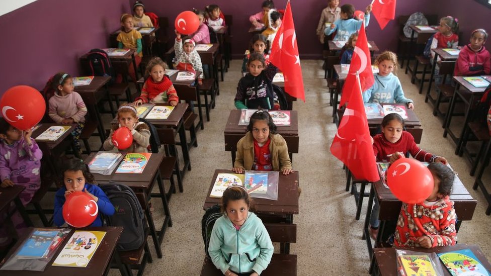 Syrian school children are seen at their classroom al-Caviz village with Turkish flags and balloons