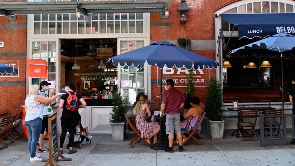 People sit at a restaurant with outdoor seating in the Little Italy neighbourhood on June 24, 2020 in New York City