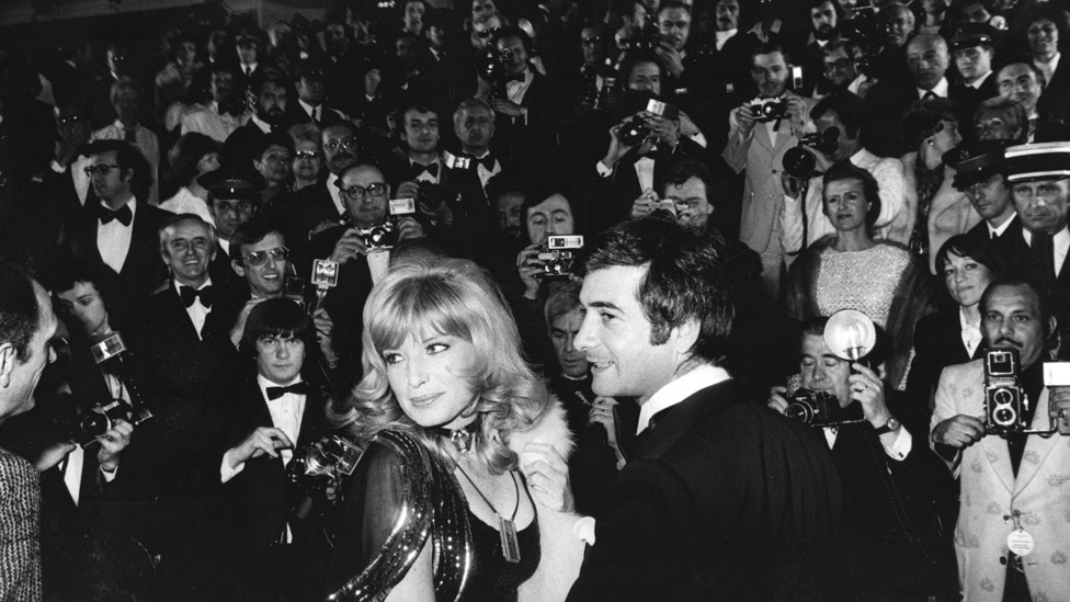 Monica Vitti and Jean-Claude Brialy surrounded by photographers at the Cannes Film Festival in 1974