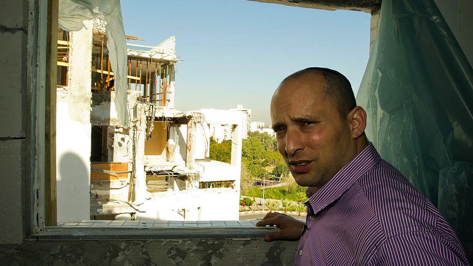 Naftali Bennett, then head of the Israeli hardline national religious party, Jewish Home, visits a destroyed apartment in 2012.