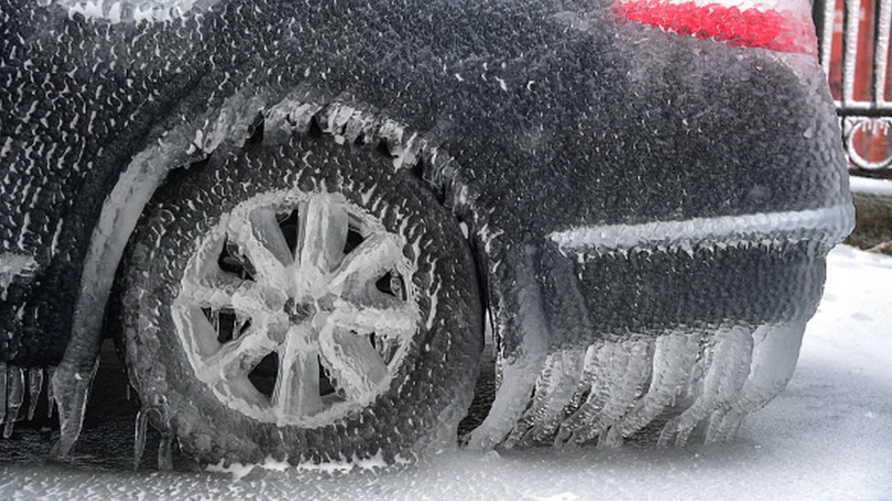 A car is covered with ice after a snowstorm in eastern Russian