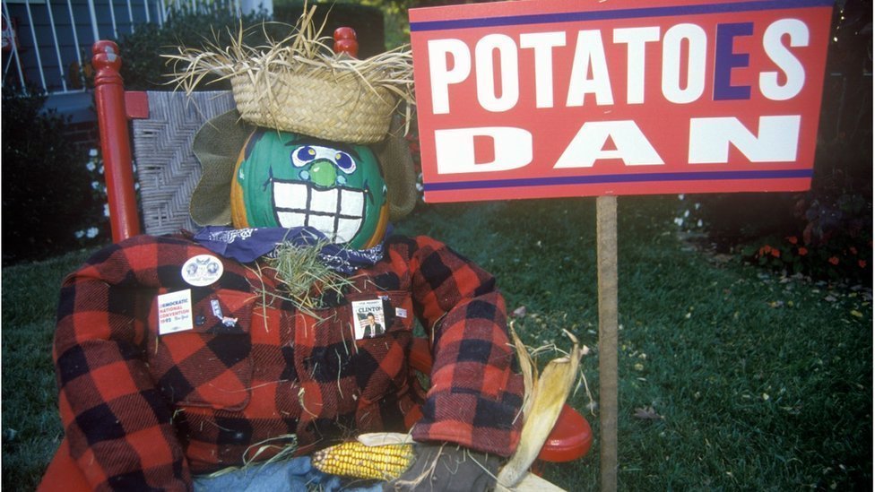 An effigy of Dan Quayle and a sign with the words 'Potatoes Dan'
