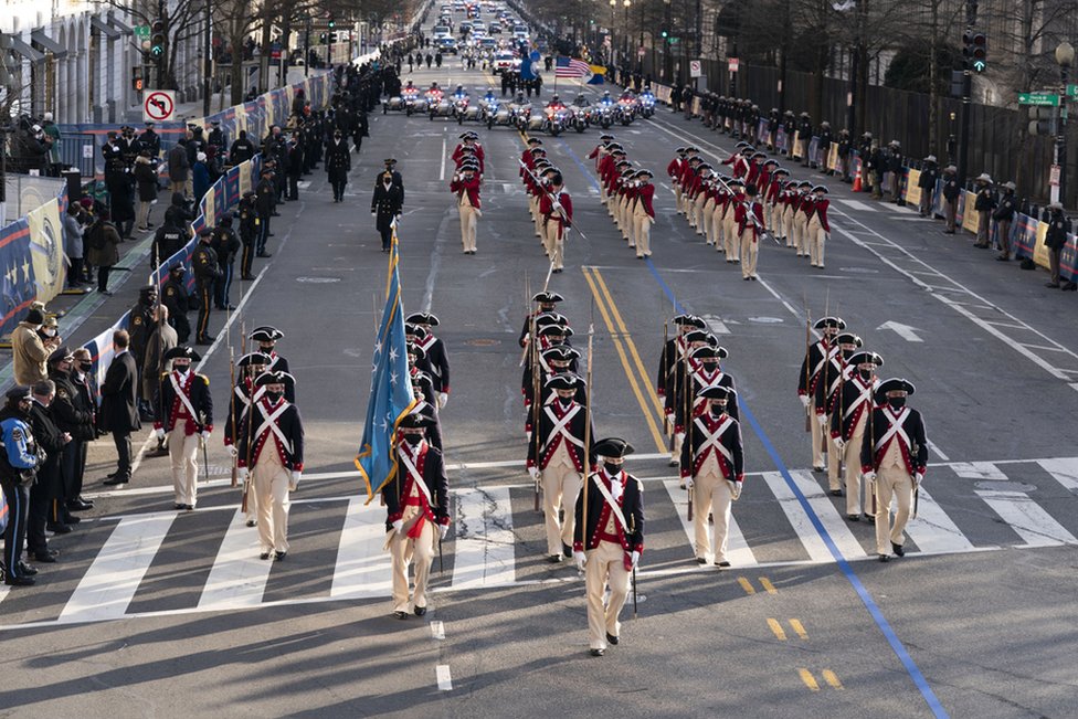 Members of the military march on 15th Street towards the White House during a Presidential Escort of US President Joe Biden's limousine to the White House, in Washington, DC, USA, 20 January 2021.