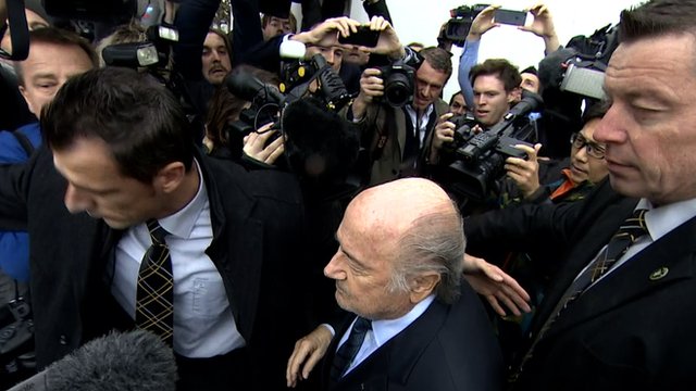 Banned Fifa president Sepp Blatter faces a media scrum in Zurich