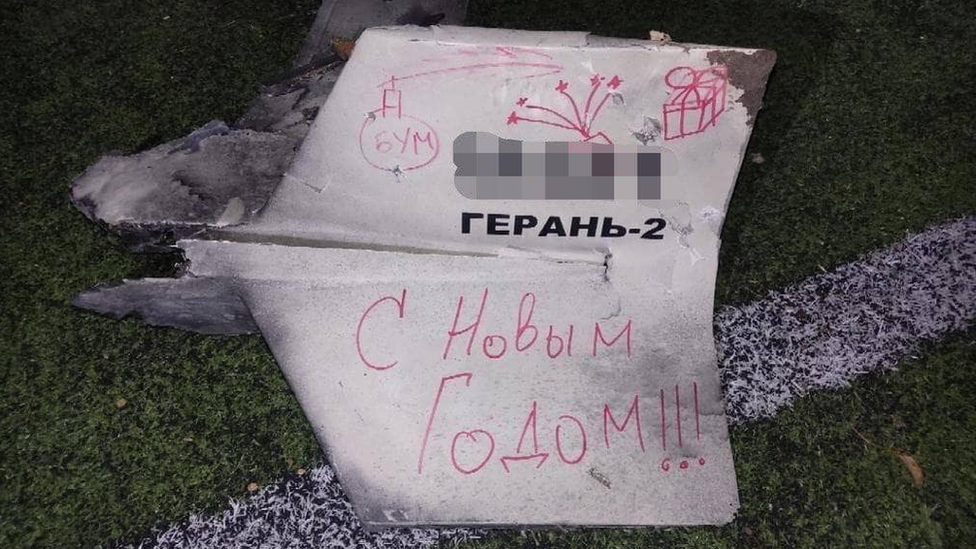 A downed drone found in a children's playground in Kyiv with the words 'Happy New Year' written in Russian on it