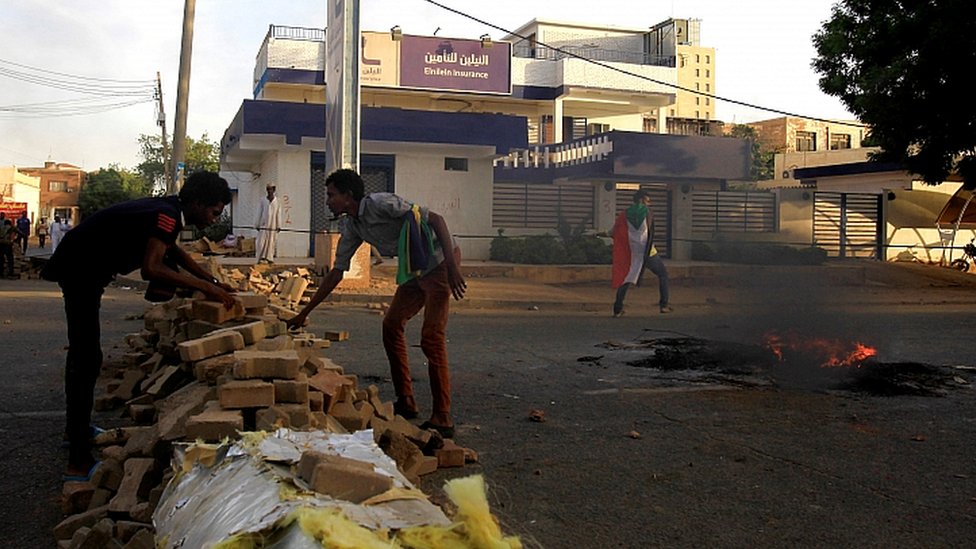 Протестующие возводят баррикаду на улице во время демонстраций в центре Хартума, Судан, 15 мая 2019 г.