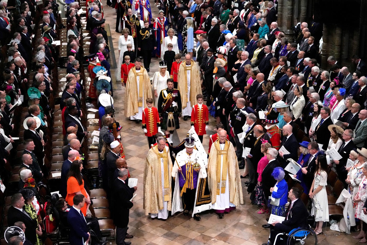 King Charles and Queen Camilla walk through Westminster Abbey after the coronation ceremony