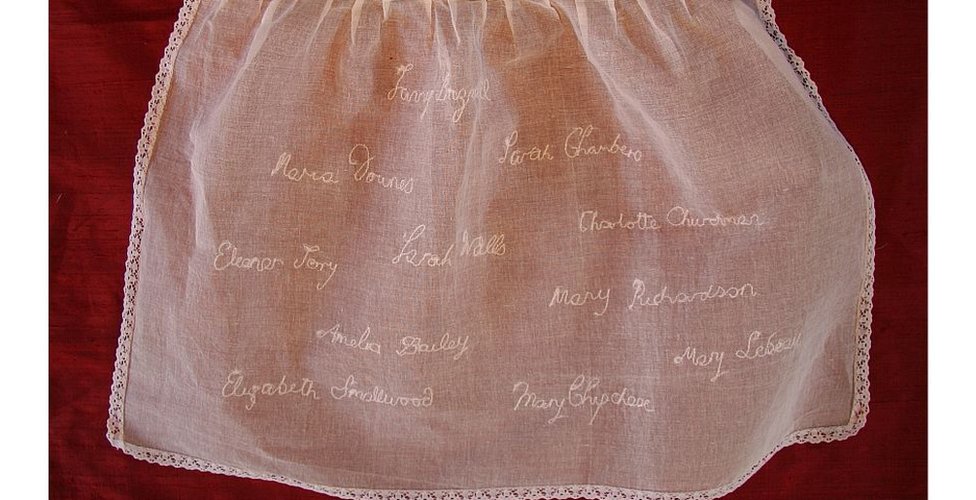 Los nombres conocidos de los niños fueron bordados en un delantal infantil.