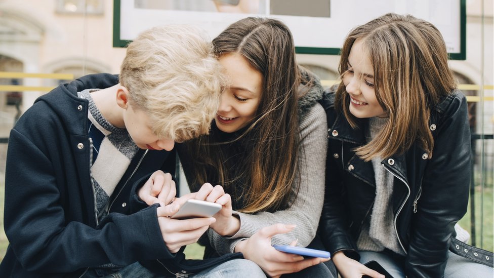 Teenagers using smartphones
