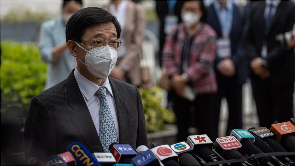 Former Hong Kong Chief Secretary John Lee Ka-chiu talks to reporters after submitting his nomination form to the Returning Officer in Hong Kong, China, 13 April 2022.