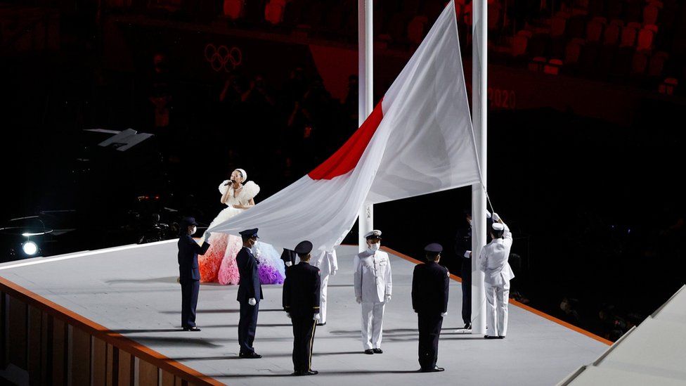 The Japan Flag is raised as the national anthem is sung during the Opening Ceremony of the Tokyo 2020 Olympic Games at Olympic Stadium on July 23, 2021 in Tokyo, Japan.
