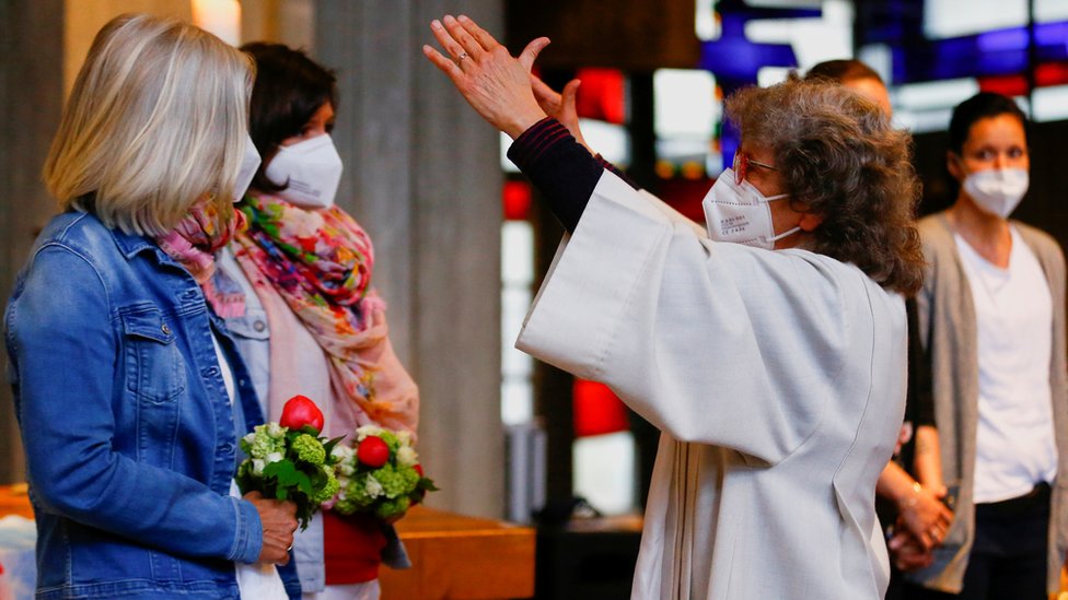 Pastoral worker Brigitte Schmidt blesses the same-sex couple Nini and Juliana Weinmeister during a ceremony in a Catholic church in Cologne, Germany, May 10, 2021