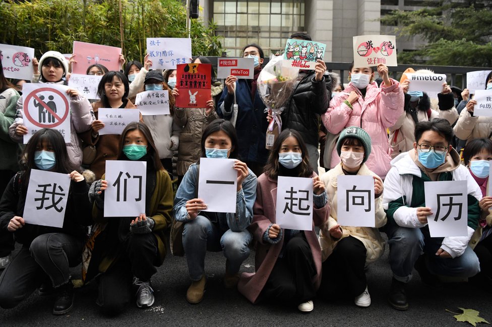 متظاهرون يرفعون لافتات تدعم شيان تسي خارج المحكمة في بكين