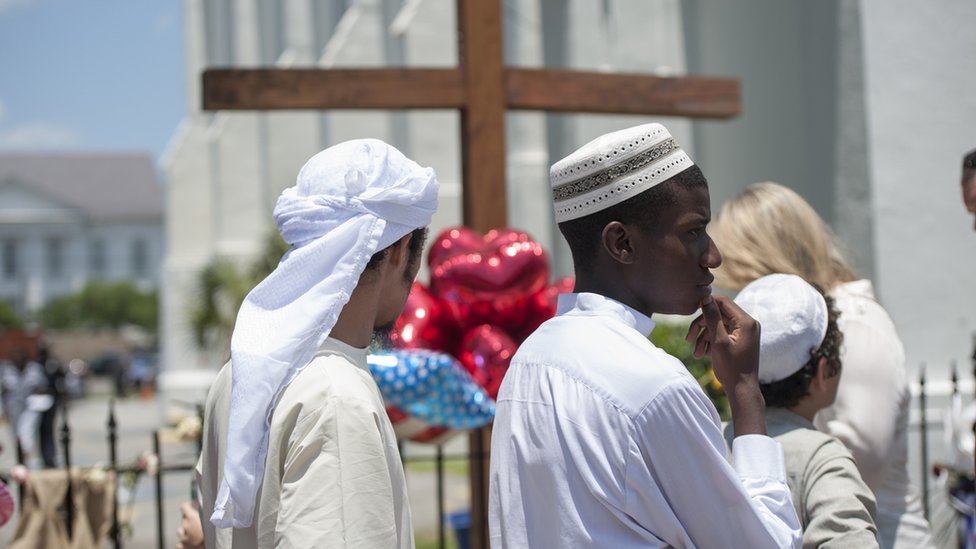 2015-06-21. Члены мусульманской общины Чарльстона выразили свое почтение в церкви Эмануэля AME в воскресенье вечером. Колм О'Моллой для BBC News.