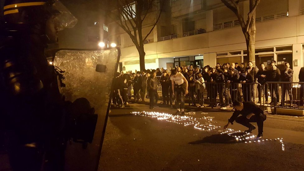 Youths use candles to write the word