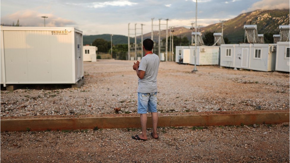 A survivor of a deadly migrant shipwreck off the coast of Greece stands inside a reception and identification camp in Malakasa, Greece on 17 June, 2023