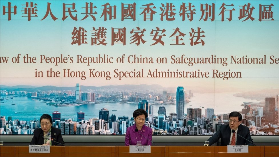 Hong Kong's Chief Executive Carrie Lam with Justice Secretary Teresa Cheng (L) and Security Secretary John Lee (R) takes part in a press conference at the government headquarters, on the 23rd anniversary of the city's handover from Britain to China, on July 1, 2020