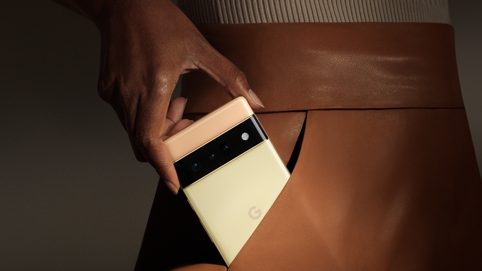 A woman places a Google Pixel 6 in her pocket