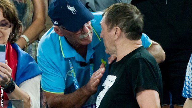 An Australian Open official speaks to a man wearing a t-shirt with a 'Z' symbol