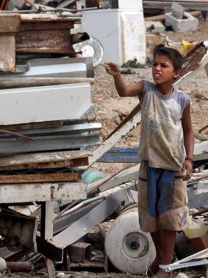 A boy collects iron and metal items to recycle and resell at a giant garbage dump in a Caracas suburb on March 17, 2009.
