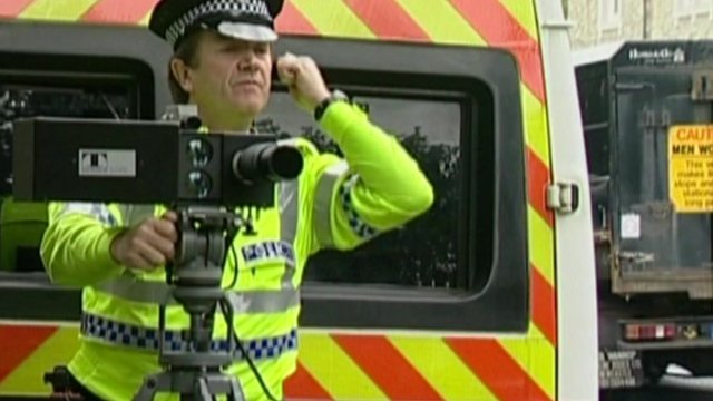 Policeman with speed camera