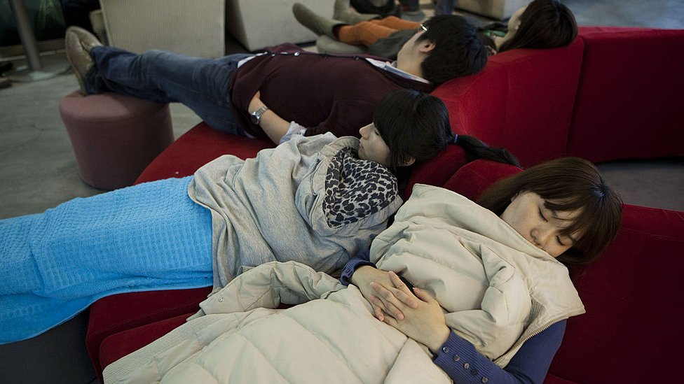 Staff members take a nap in the recreation room at the head office of Renren Inc. in Beijing, China, on Monday, Feb. 13, 2012.