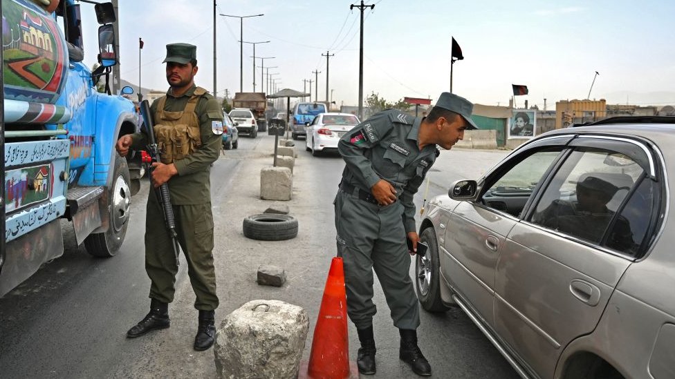 A polícia afegã monta guarda em um posto de controle ao longo da estrada em Cabul em 14 de agosto de 2021