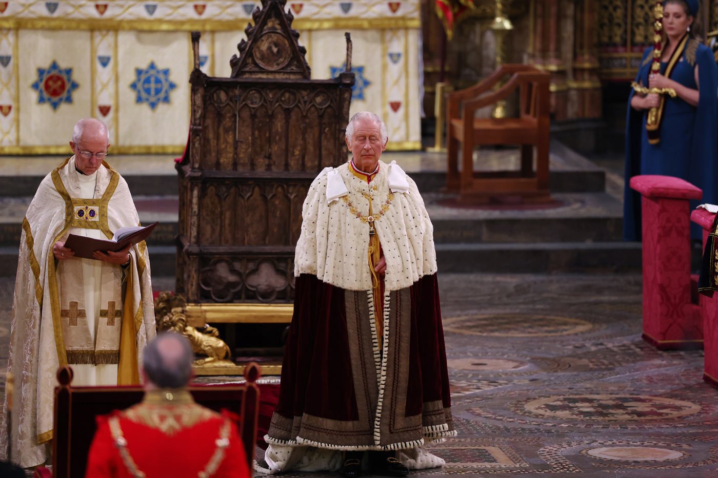 King Charles III stands while closing his eyes during the coronation ceremony