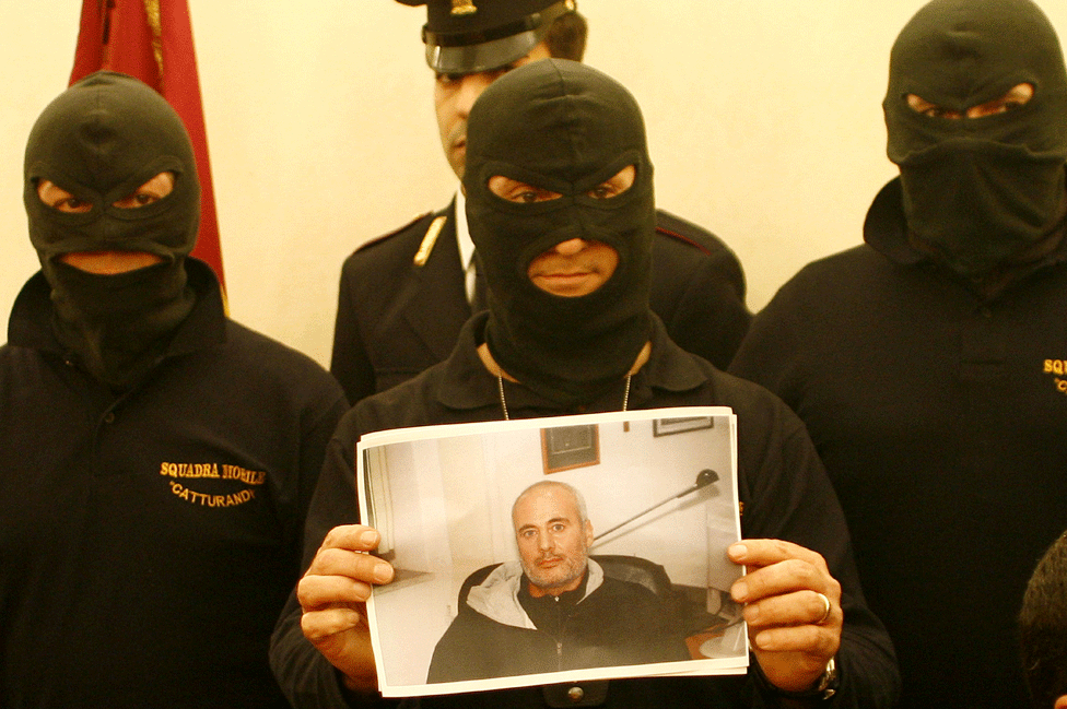 Catturandi officers show a picture of Mafia boss Domenico Raccuglia
