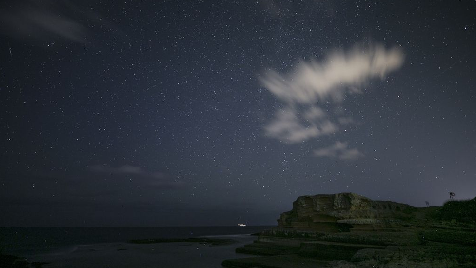 A Perseid meteor, also known as "Shooting Star", streaks across the sky at Kefken Pink Rocks in Kandira district of Kocaeli, Turkey on August 13, 2018.