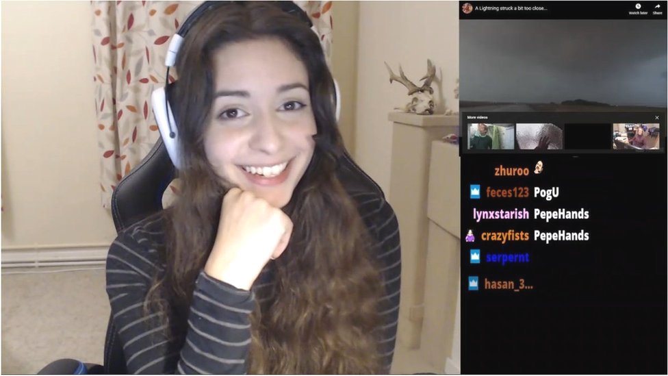 A still image from one of Anita's streams, it shows her on the left smiling into the camera, on the right hand side is a chat column with a few messages from her viewers.
