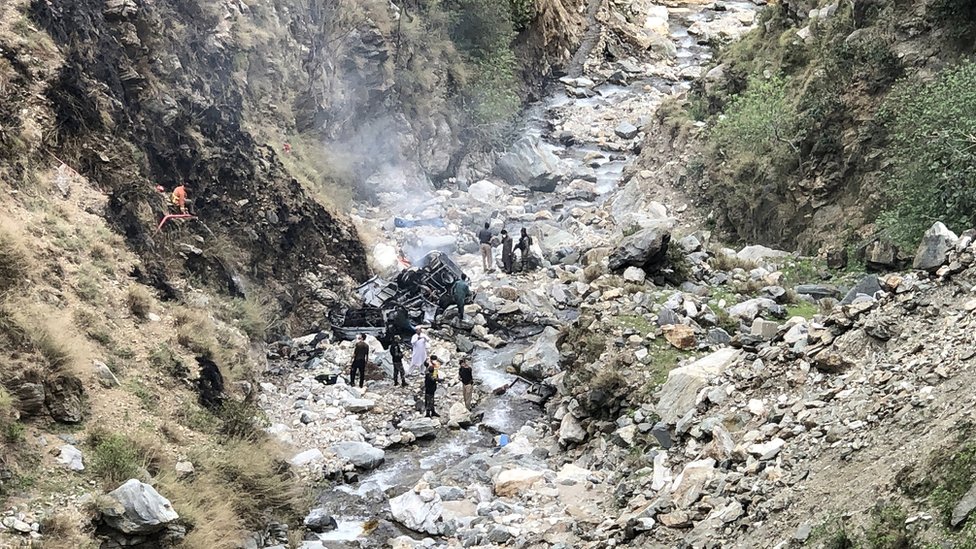 Security officials inspect the wreckage of a vehicle which was carrying Chinese nationals that plunged into a deep ravine off the mountainous Karakoram Highway after a suicide attack near Besham city in the Shangla district of Khyber Pakhtunkhwa province on March 26, 2024. Five Chinese nationals working on a major dam construction site were killed along with their driver on March 26 when a suicide bomber targeted their vehicle in northwest Pakistan, officials said.