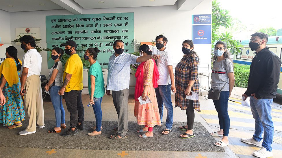 People queue to receive vaccines in Delhi, India on 6 June