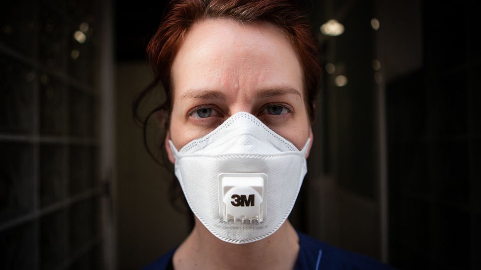 A Spanish healthcare worker wears a mask