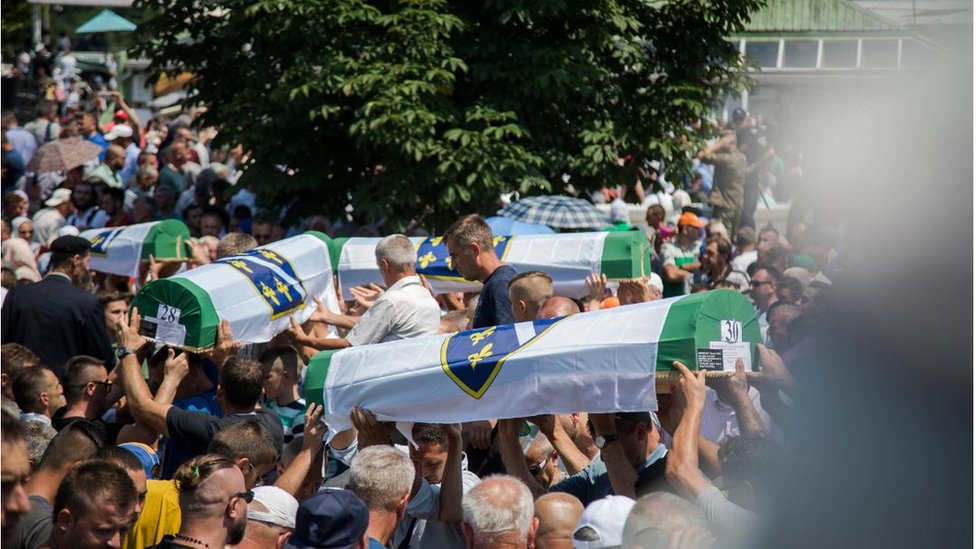 Grupa ljudi nose tabute, Potočari, 2018.