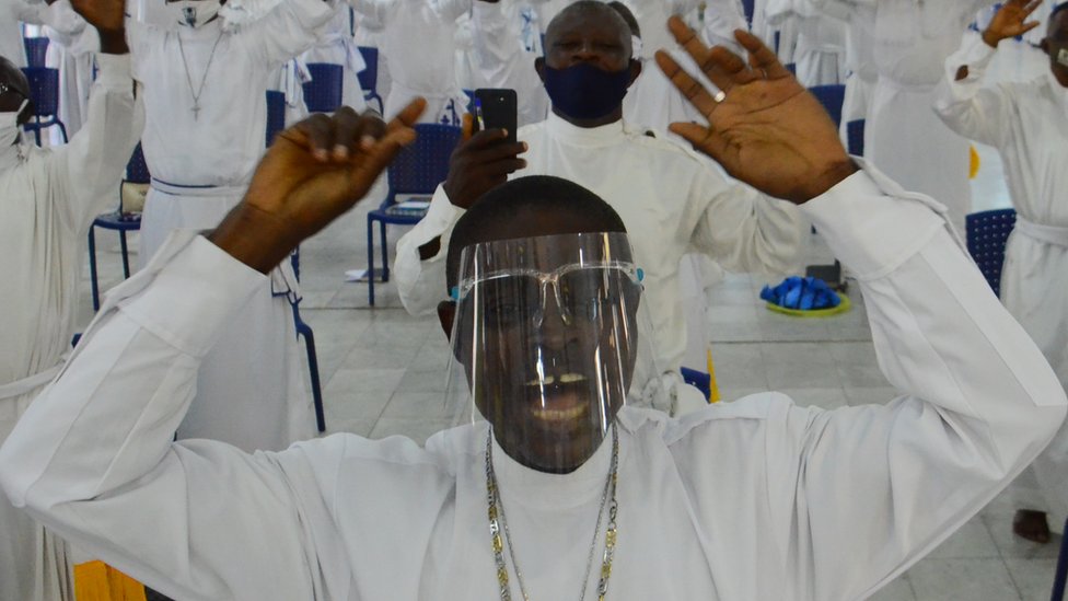 Worshippers wearing facemask sings as worship centers reopen after the COVID-19 lockdown, at the Celesitail Church of Christ, Arch Diocese National Headquarter Makoko, Lagos, as measures against the spread of COVID-19 Coronavirus in Lagos, Nigeria on August 8, 2020