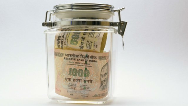 Indian rupees in a jar