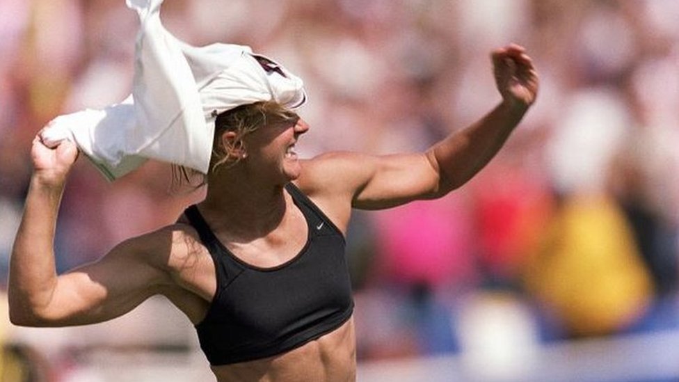 Brandi Chastain of Team USA removes her jersey while celebrating Final match over Team China